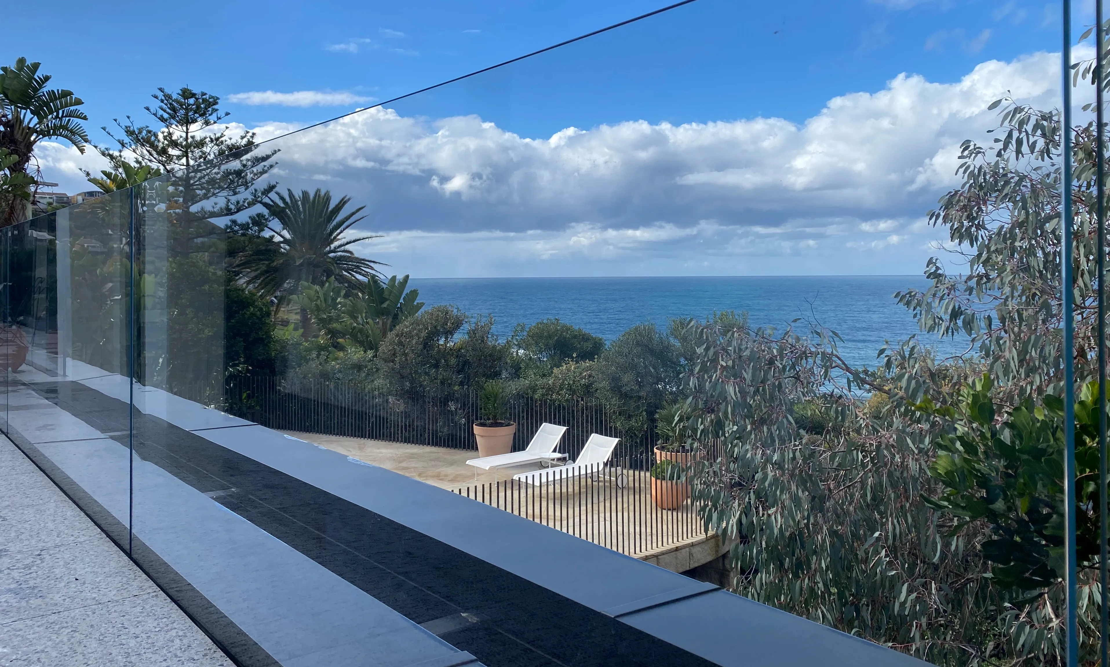 Frameless glass pool fencing around a Sydney backyard pool